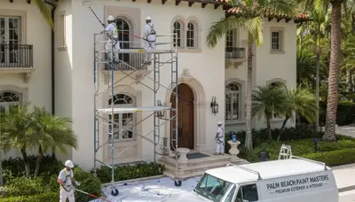 Professional painters applying fresh interior paint in West Palm Beach, FL area home